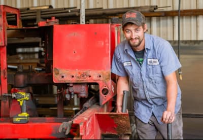 A worker smiling while he works
